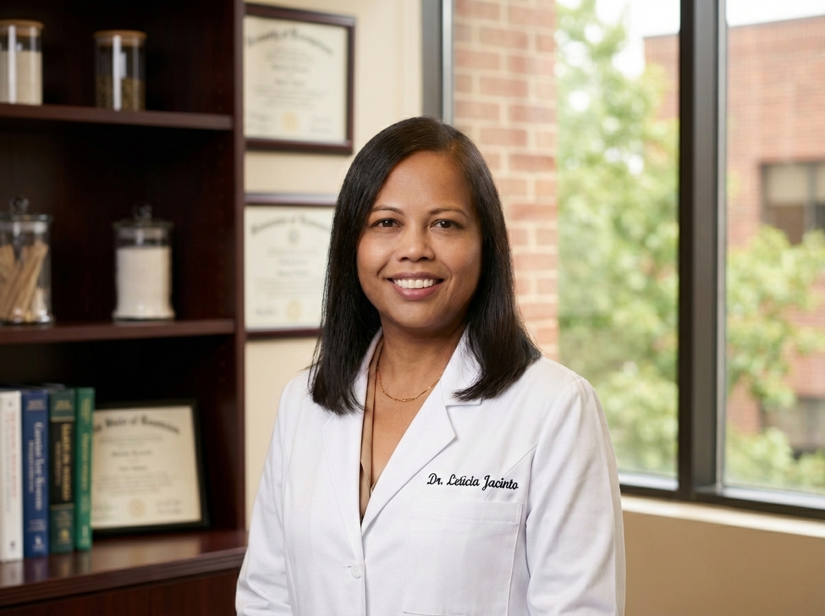 Professional Hispanic woman doctor in white coat with stethoscope smiling warmly in medical office
